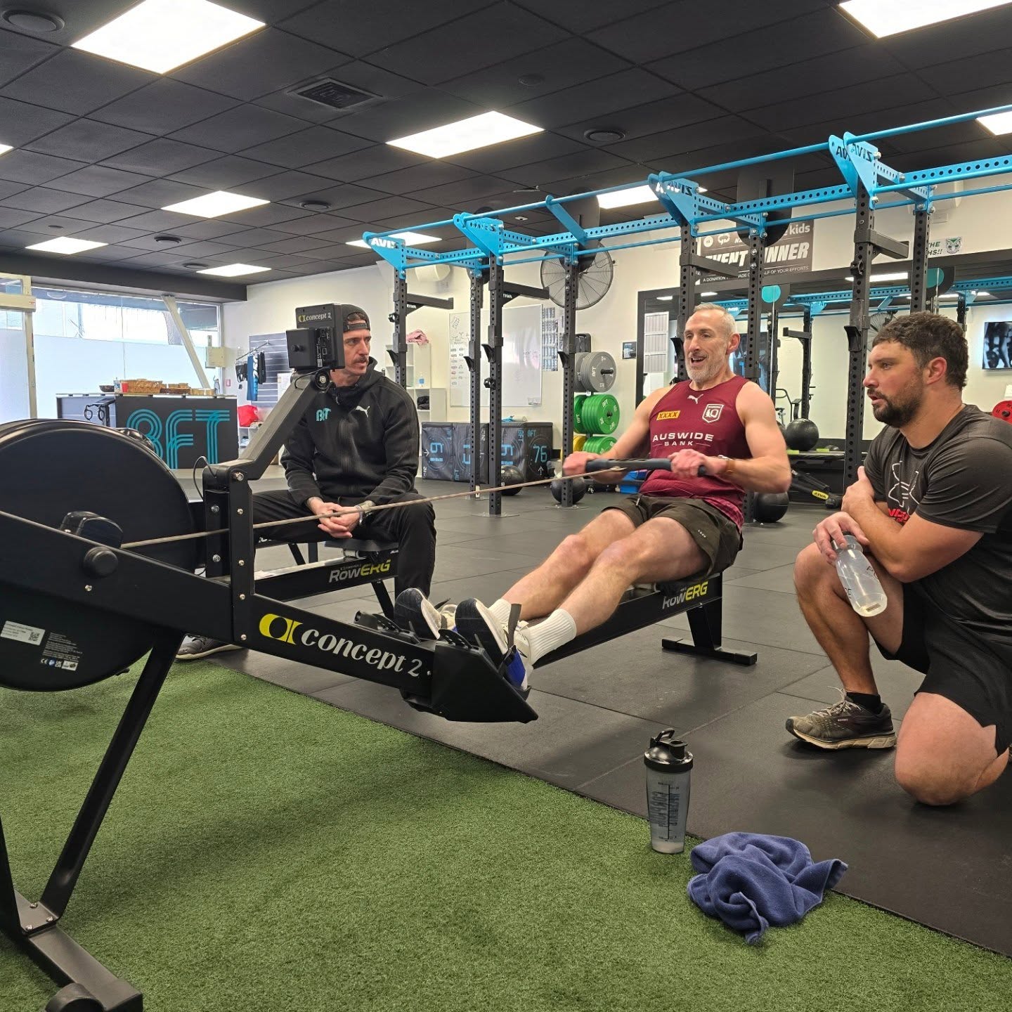 BFT Upper Hutt coach guiding a member on the rower